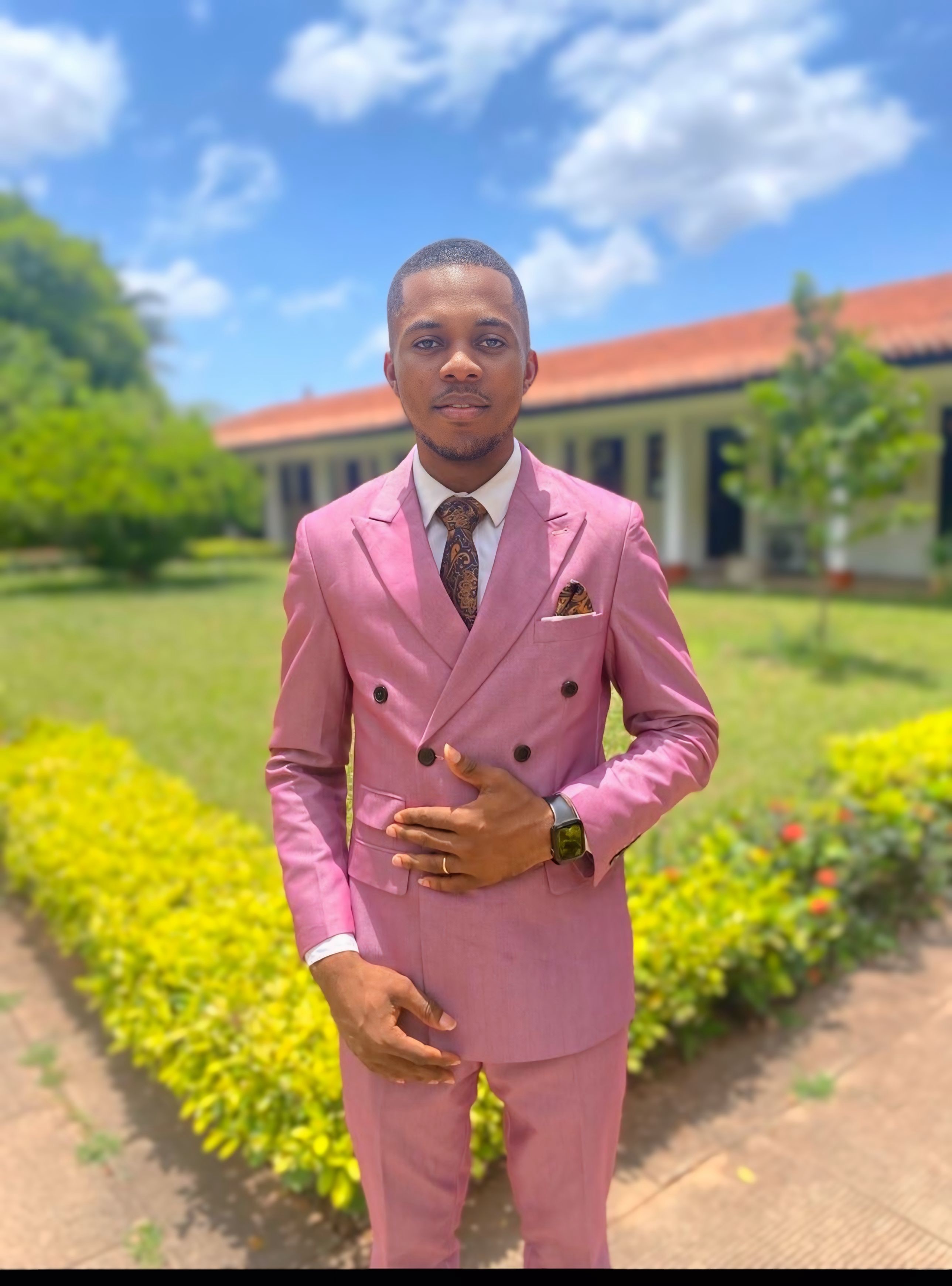 Pastor Samuel A. Ewool in a pink suit outdoors